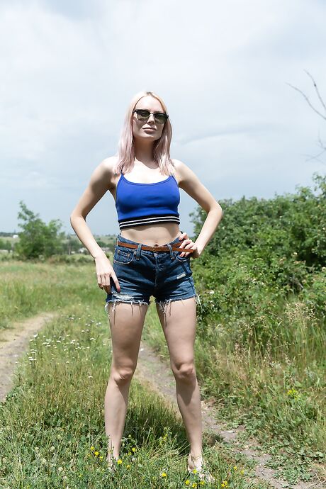 Horny babe Maria Rubio removes her shirt and denim shorts and poses outdoors